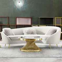 a modern living room with white couches and gold accents