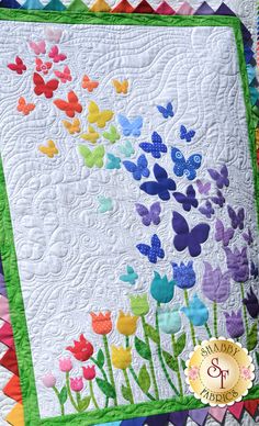 a quilted bench with flowers on it and the words, blooming butterflies written in white