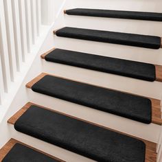 a set of black carpeted stairs leading up to the top