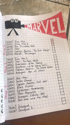 an open notebook with a list on it and the words'marvel'written in red