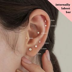 a woman with three different piercings on her ear and behind the ear is an image of