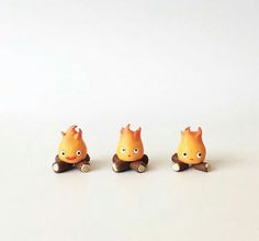 three small toy animals sitting on top of each other