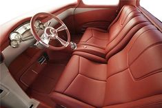 the interior of an old car with red leather