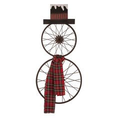 a bicycle wheel with a red tartan ribbon hanging from it