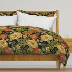 a bed with floral comforter and pillows on it