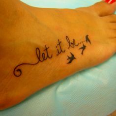 a woman's foot with the word faith written on it and birds flying around