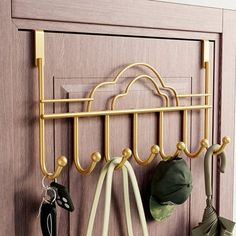 a coat rack with umbrellas and hats hanging from it's hooks in front of a door