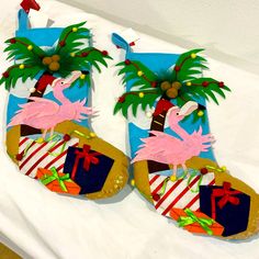 two decorated christmas stockings sitting on top of a bed