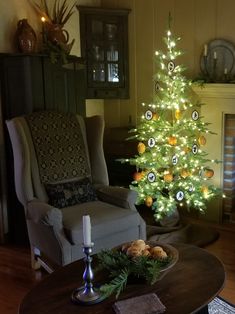 a living room with a christmas tree in the corner and other decorations on the table