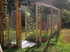 an outdoor garden with flowers and trelliss on the fenced in side yard