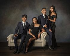 three people in formal wear posing for a photo with one woman and the other man