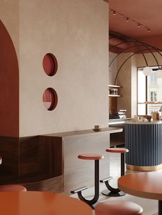 the interior of a restaurant with round tables and stools