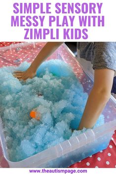 a plastic container filled with blue foam next to a child's hand in it