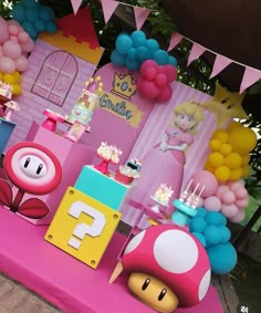 a mario birthday party with balloons and decorations