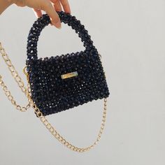 The shiny black bead bag, made with care and 100% hand labour, is a great option to accompany you on your special days. You can gift it to your loved ones. Gold chain detail gives a different aesthetic to the handmade black bead bag. It will be sent in a storage pouch and you can keep your bag in this way. Your phone, lipstick, airpods, cards and other minimal items can easily fit inside.  *Details - Completely handmade - High quality, colourfast acrylic beads - Suitable for phone, wallet, basic Evening Rectangular Bags With Black Beads, Black Top Handle Bag With Pearl Handle, Gift Black Beaded Shoulder Bag, Black Beaded Square Shoulder Bag, Black Handheld Bags With Pearl Handle, Black Handheld Bag With Pearl Handle, Rectangular Bag With Black Beads As Fashion Accessory, Black Rectangular Evening Bag With Black Beads, Black Beaded Evening Bag As Gift