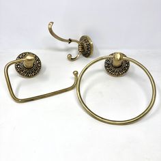 a pair of brass - plated metal towel rings and ring holders are shown on a white background