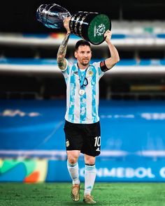 the soccer player is holding up his trophy