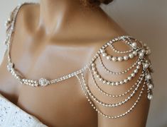 a mannequin with pearls and chains on it's back neck, wearing a white dress