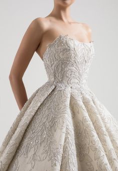 the back of a wedding dress with beading and sequins on it's skirt