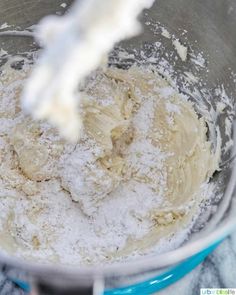 a mixing bowl filled with batter and powdered sugar