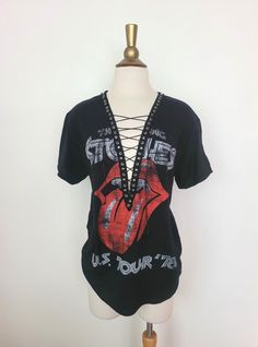 "Rolling Stones Lace Up T-Shirt with Gunmetal Studs Detailed Trim Each piece is uniquely designed and one of its' kind. Hand stitched edge detailing for superior quality and unique finish. Please note, since this is a handmade item, there may be slight variances with each T.  UNISEX Sizing (women may choose to size down depending on fit preference) Pictured size M on M form, for reference. Appx. Measurements Laying Flat: S: 17\" across chest Width x 28\" Length M: 19\" across chest Width x 29\" Length L: 21\" across chest Width x 31\" Length XL: 23\" across chest Width x 32\" Length XXL: 25\" across chest Width x 33\" Length ** If you have a custom idea or would like to mix and match a design idea seen in my shop, feel free to contact me anytime **" Spring Grunge T-shirt For Alternative Fashion, Summer Rock T-shirt With Band Logo, Vintage Distressed T-shirt For Festivals, Edgy Festival T-shirt With Crew Neck, Spring Rock Style Crew Neck T-shirt, Edgy Acid Wash T-shirt For Alternative Fashion, Distressed Band Merch T-shirt For Summer, Summer Band Merch Distressed T-shirt, Distressed Rock T-shirt For Streetwear