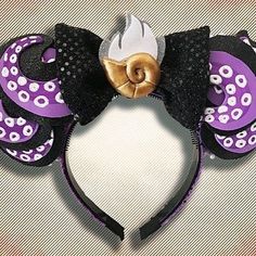 a purple and black mickey mouse ears headband with an octopus on the side,