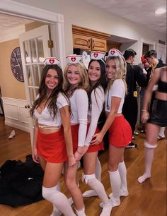 four girls dressed up in costumes posing for the camera