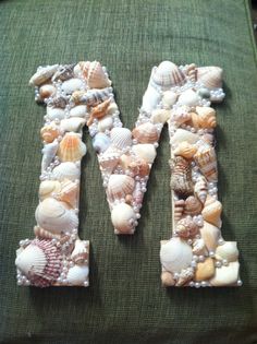 the letter m is made out of sea shells