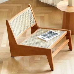 a wooden chair sitting on top of a hard wood floor next to a coffee table