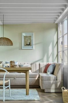 a living room filled with furniture and a wooden table