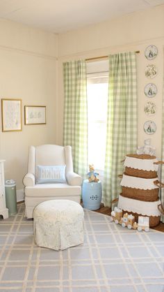 a baby's room decorated in white and green with a large cake on the floor