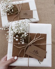 two wrapped packages with flowers tied to them