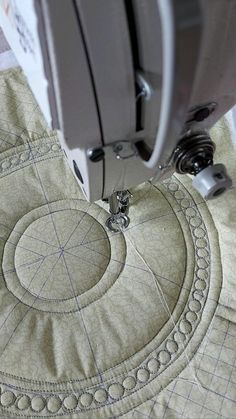 a close up of a sewing machine on a piece of fabric that has been stitched together