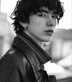 black and white photograph of a young man wearing a leather jacket