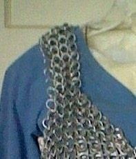 a blue shirt with silver chains on it