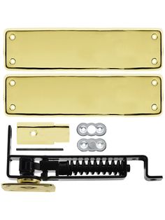 two brass plated guitar pickers with hardware and screws on each side, set against a white background