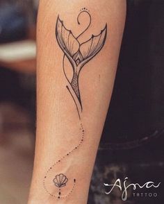 a black and white photo of a woman's arm with a flower tattoo on it