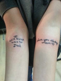 two people with tattoos on their arms that say i love you daddy and mom dad