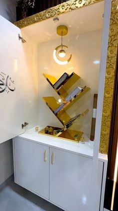 a white cabinet with gold and black designs on the front, in a room that looks like it has been designed to look like a pyramid