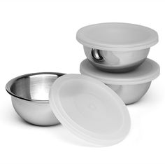 three bowls and one bowl are stacked on top of each other, with lids in the middle