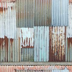 an old rusty metal wall that has been painted rusted and chipped with paint