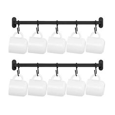 six white mugs hanging from a black rail