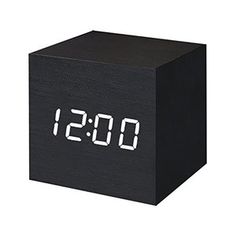 an alarm clock with the time on it's face is shown in black wood