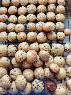 there are many cookies and muffins on the cooling rack