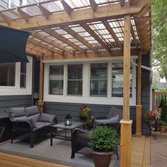 a covered patio with furniture and an umbrella