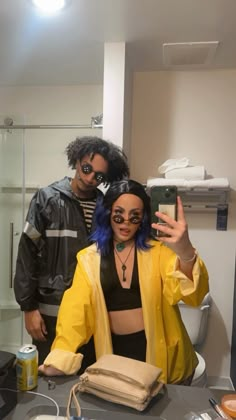 a man and woman taking a selfie in the bathroom