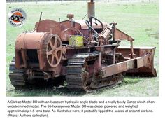 an old tractor is parked in the grass