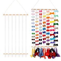 an assortment of bow ties hanging on a wall next to a rack with several different color bows