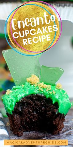 a chocolate cupcake with green frosting and gold foil on top that says encanto cupcakes recipe