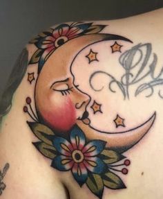 a woman's back with a crescent and stars tattoo on the side of her stomach